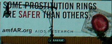A poster on West Side Highway depicting a condom, "Some Prostitution Rings Are Safer Than Others".
